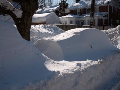 Car buried in snow.